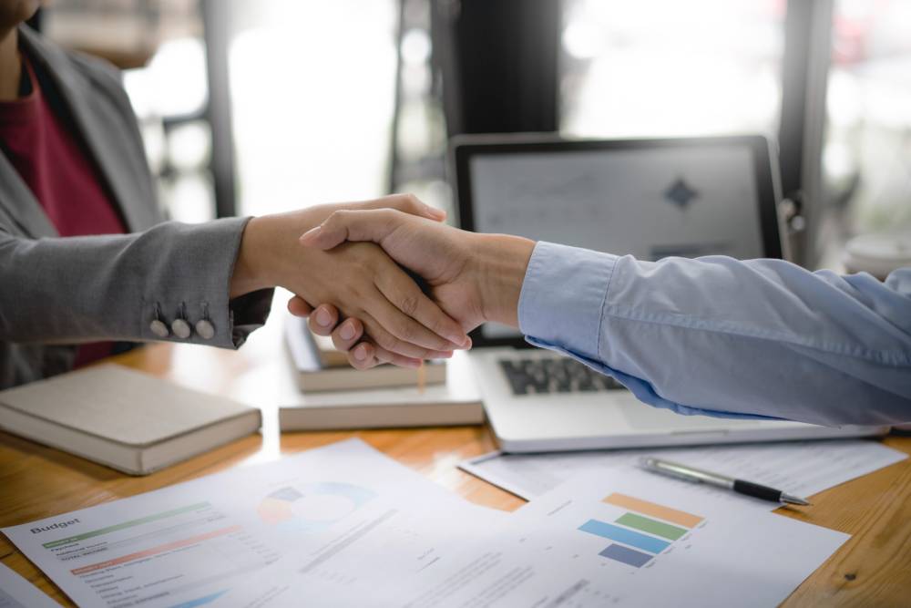 A client and a lawyer shake hands after a consultation.